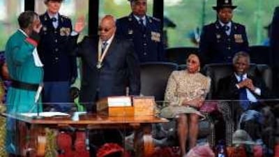Jacob Zuma is sworn in by Pius Langa, left, the chief justice, as the former president Thabo Mbeki and his wife Zanele look on, in Pretoria.