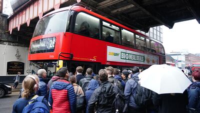 Long queues for a bus form outside Waterloo station. PA