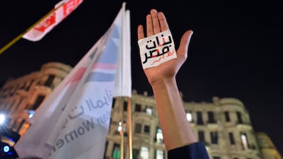 An Egyptian protester holds up his hand with an Arabic slogan reading 'Egyptian girls are a red line' at a demonstration in Cairo. AFP
