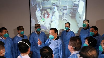 Chinese Premier Li Keqiang wearing a mask and protective suit speaks to medical workers as he visits the Jinyintan hospital where the patients of the new coronavirus are being treated following the outbreak, in Wuhan, Hubei province, China. Reuters