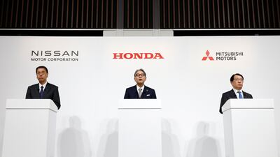 From left, Nissan Motor's president and chief executive Makoto Uchida, Honda Motor's president Toshihiro Mibe, and Mitsubishi Motors' president and chief executive Takao Kato speak at a joint press conference in Tokyo on Monday. EPA