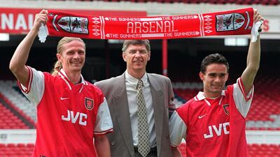 Arsene Wenger (C) with the club's new signings, Emmanuel Petit (L) and Marc Overmars in June 1997. Adrian Dennis / AFP