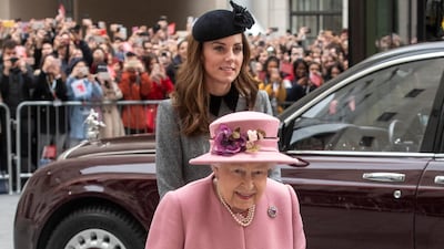 For the joint visit, Queen Elizabeth II wears a Stewart Parvin Old Rose cashmere coat, a Rachel Trevor-Morgan hat and Cornelia James gloves. Reuters