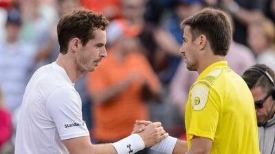 Andy Murray, left, shakes hands with Tommy Robredo after winning their Montreal Masters second round match 6-4, 7-5. Minas Panagiotakis / Getty Images