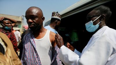 A man is vaccinated at Wuse market in Abuja, Nigeria. Reuters