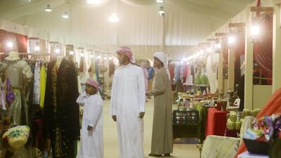 Men walk through the traditional souk at the festival.