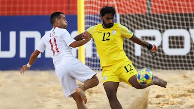 Leo Martins (L) of Portugal vies for the ball with Younis Al Owaisi, goalkeeper of Oman. EPA
