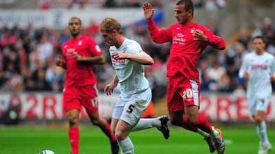 Alan Tate, centre, says he and his Swansea City teammates have faced tougher situations than opening at Manchester City.