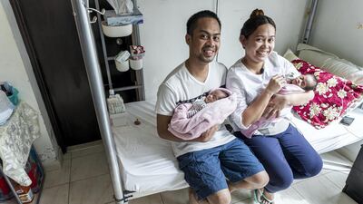 John and Monica Pentio Tubo at home with their young daughters
