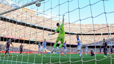Pedro Rodriguez scores the opener for Barcelona on Saturday past Sociedad keeper Geronimo Rulli to make it 1-0 in their La Liga contest. David Ramos / Getty Images