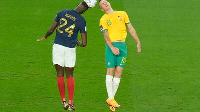 France's Ibrahima Konate, left, and Australia's Mitchell Duke jump for the ball. AP