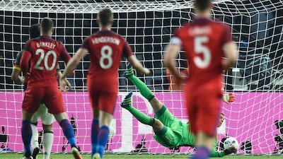 Germany’s goalkeeper Manuel Neuer fails to save the ball for the 2-2 goal during the friendly football match Germany v England at the Olympic Stadium in Berlin on March 26, 2016. / AFP / ODD ANDERSEN