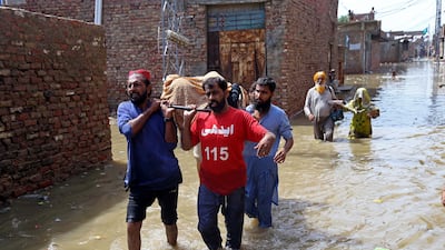 Workers of the non-profit Edhi Foundation assist people affected by floods in Hyderabad, Pakistan. EPA