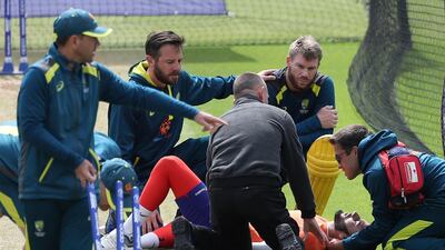 David Warner, second right, and medics attend to Jaykishan Plaha after he was struck on the head by a ball during a nets session. AP Photo