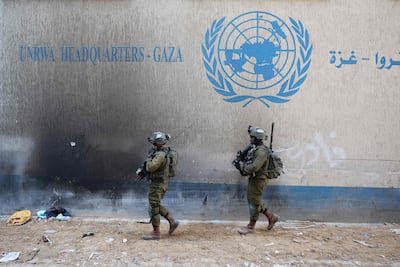 Israeli soldiers inside an evacuated compound of the United Nations Relief and Works Agency for Palestine Refugees (UNRWA) in Gaza city. AFP