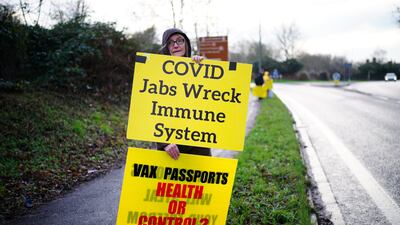 An anti-vaxxer on the side of the A39 carriageway in Glastonbury in Somerset. PA