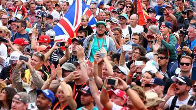 Formula One fans gather along the pit straight to watch the drivers on the podium after the Belgian Grand Prix on Sunday at Spa-Francorchamps. Mark Thompson / Getty Images