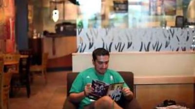 Dr Hassan Galadari relaxes and catches up on his latest comic purchase at a coffee shop in Dubai.