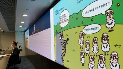 Li Kwai-wah, senior superintendent of Hong Kong's Police National Security Department, speaks in front of a screen showing illustrations from children's books that officials said promoted sedition. AP