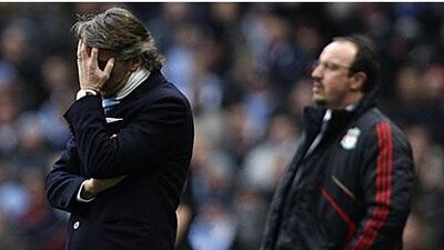 Manchester City's manager Roberto Mancini, left, is seen alongside Liverpool manager Rafael Benitez during a frustrating afternoon for both managers at Eastlands.
