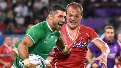 Rob Kearney, who scorted Ireland's first try on Thursday, attempts to hold off the attentions of Russia's Denis Simplikevich in Kobe. Reuters
