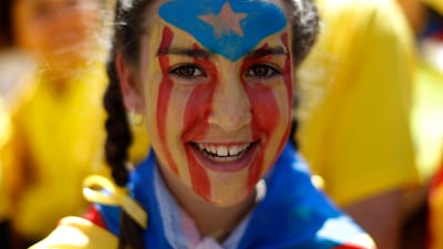 A girl with her face painted with an estelada or independence flag is photographed during the protest. AP/Manu Fernandez