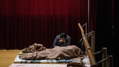 A woman rests in a shelter for residents of the village of Lei Yu Mun in Hong Kong. AFP