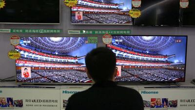 A man watches a broadcast of Chinese President Xi Jinping deliver his speech to open the congress. Reuters