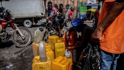 A woman sells petrol in Port-au-Prince. AFP