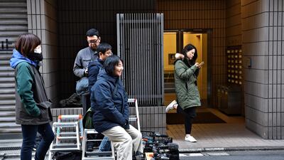 Members of the media wait outside an entrance to the offices of the Japanese lawyers for former Nissan chief Carlos Ghosn in Tokyo. AFP