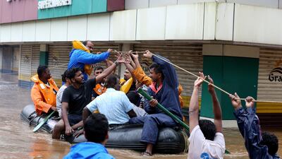 Rescue workers evacuate people from flooded areas after the opening of Idamalayr, Cheruthoni and Mullaperiyar dam shutters following heavy rains, on the outskirts of Kochi, India, August 16, 2018. Reuters