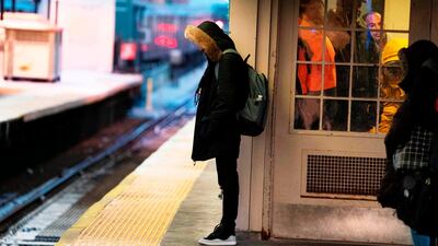 A young man waits on a subway platform in freezing temperatures in New York. AFP