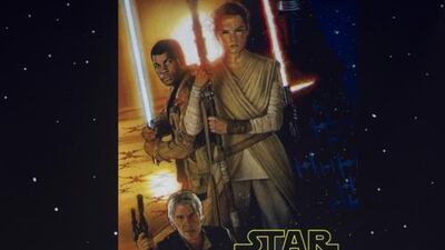 The Force Awakens director JJ Abrams, second right, and cast with the first poster for the film at the D23 event. Disney / Image Group