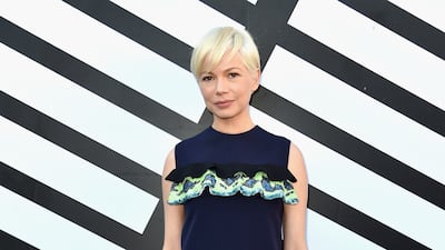 Michelle Williams attends the Louis Vuitton spring/summer 2017 Paris Fashion Week show in a blue dress by the brand, on October 6, 2016. Getty Images
