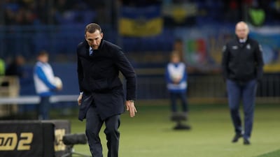 Ukraine coach Andriy Shevchenko kicks the ball after it goes out for a throw-in. Reuters