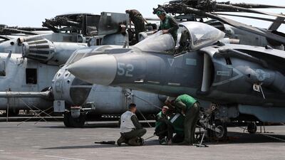 US Marines maintain aircraft on the flight deck.