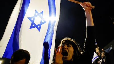 A protester shouts anti-government slogans in Jerusalem after Israel's Defence Minister was dismissed. Reuters