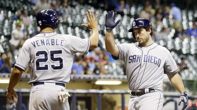 San Diego Padres' Brett Wallace is congratulated by teammate Will Venable after hitting a two-run home run during the ninth inning against the Brewers on Wednesday, Aug. 5, 2015, at Milwaukee. Morry Gash / AP Photo