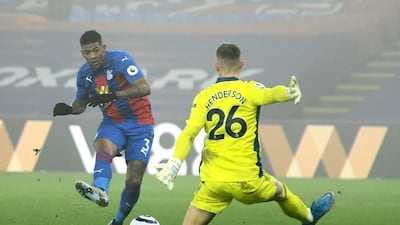 Crystal Palace's Patrick van Aanholt takes on Manchester United's goalkeeper Dean Henderson. AP