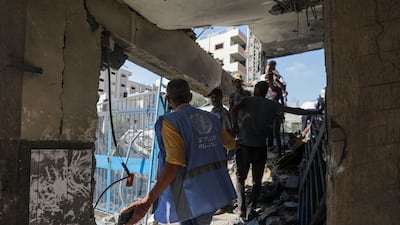 Palestinians inspect a damaged UNRWA school following an Israeli air strike in Al Nuseirat refugee camp in the central Gaza Strip this week. EPA
