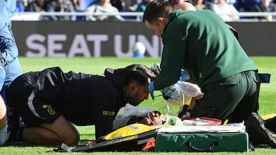 Chelsea's Argentinian goalkeeper Emi Martinez is treated after picking up a head injury during the match against Everton at Hill Dickinson Stadium in Liverpool. AFP