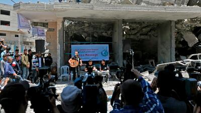 Palestinian journalists film as members of the band Dawaween perform in Gaza City. AFP