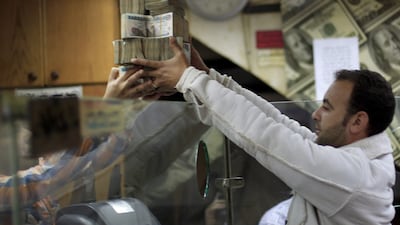 The Egyptian currency was devalued to 8.85 pounds per US dollar from the official rate of 7.73 pounds. Khalil Hamra / AP Photo