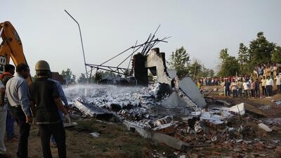 Firefighters douse flames after an explosion at a fireworks factory in Khari village, Balaghat, Madhya Pradesh. EPA