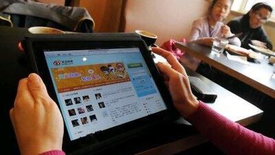 A woman views the Chinese social media website Weibo at a cafe in Beijing. Everyone who is anyone, it seems, believes that they must engage with China.