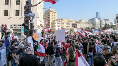 Lebanese students from various Universities carry placards and wave national flags during a protest in Beirut, Lebanon. EPA
