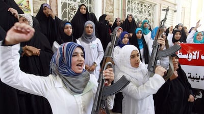 Iraqi women in the southern Shiite Muslim shrine city of Najaf brandish weapons to show their willingness to join Iraqi security forces in the fight against militants who have taken over several northern Iraqi cities. Haidar Hamdani / AFP / June 18, 2014