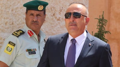Turkish foreign minister Mevlut Cavusoglu at a welcome ceremony during the visit of the Turkish president in Amman, Jordan on August 21, 2017. Mr Cavusoglu is expected to hold talks in both Baghdad and Erbil on Wednesday. Khalil Mazraawi / AFP