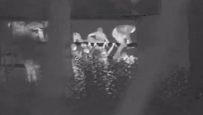 Thermal imaging surveillance footage shows the migrants cramming on to a lorry at night to be take to France. Photo: NCA