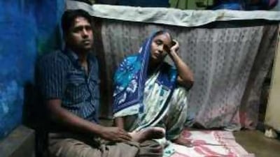 Aftab Alam Ansari sits with his mother Ayesha Bibi as he recounts the horror he experienced in police custody.